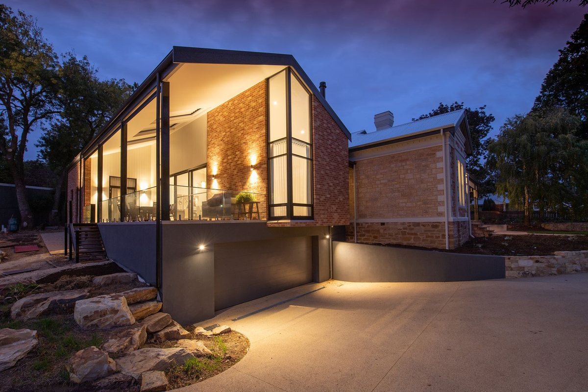 Modern home glowing at dusk — King George Corridor, South Surrey